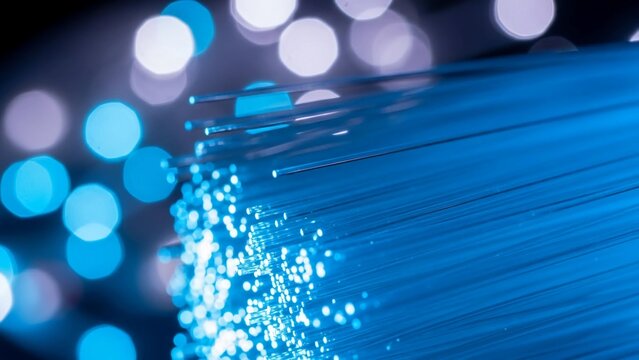 Macro Close-Up of Glowing Blue Fiber Optic Cable Strands with Bokeh Background for High Speed Internet Technology Concept - Powered by Adobe