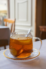 glass cup of tea with lemon on table