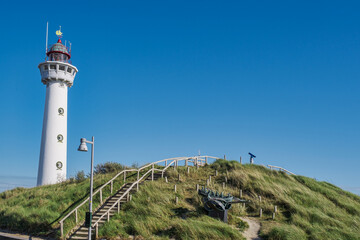 The Egmond aan Zee lighthouse in the Netherlands against a blue sky