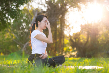 Calm woman doing breathing practice outdoors