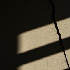 High contrast natural light falls across rough stucco, creating deep, fragmented shadows and sharp lines that convey movement and modern abstraction ,modern ,conceptual ,background