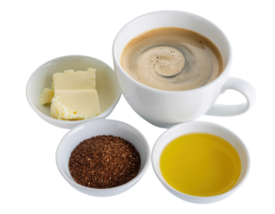 A steaming cup of coffee surrounded by bowls of butter, ground flaxseed, and olive oil, showcasing a blend of rich ingredients.