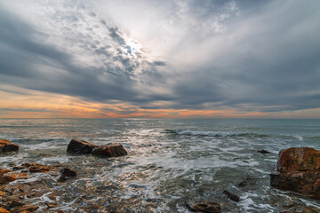 view of a calm sea on a cloudy winter day, a poster about a winter vacation on the Mediterranean Sea