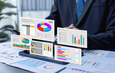 Businessman reviewing performance dashboards for marketing and operations, analyzing finance, sales, KPI, human resources, ISO standards, and quality control to improve organizational development.