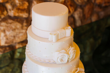 Elegant White Four-Tier Wedding Prop Cake with Ribbons and Sugar Flowers