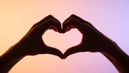 Obraz premium Hands forming a heart shape against a vibrant gradient background
