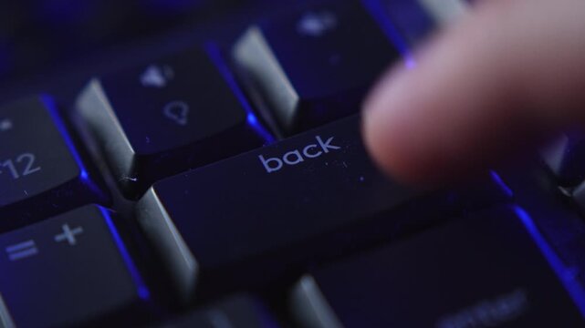 Finger repeatedly pressing backspace key on keyboard