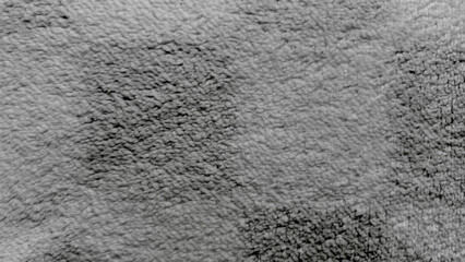 grayscale closeup of stained shaggy carpet texture dividing dirty and clean sides evoking grungy industrial mood ideal for background wallpaper or web design banner with copy space