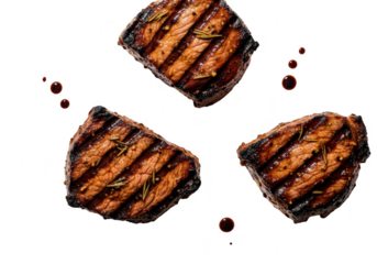 Three perfectly grilled steaks with rosemary and spices on a black background