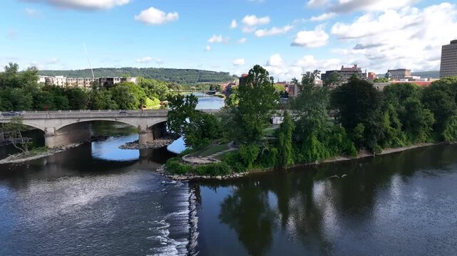 Binghamton, NY downtown city skyline with office buildings, historic architecture, public parks and river flowing through town on Summer sunny warm day