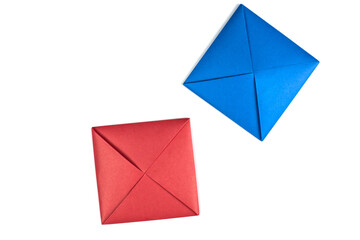 Blue and red game squares for Ttakji. Game of throwing piece into ground to flip enemy piece. Idea for creating game using paper. Ttakji on white background, concept for simple game variation