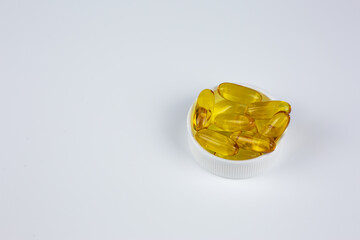 Recommended use of Omega 3 vitamin in gelatin capsule with fish oil. Universal dietary supplement for taking with food. Concept of medical, health and wellness. Vitamins for elderly and young