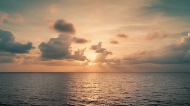 Warm glowing sunset clouds rolling across the horizon over a calm ocean surface. Soft tones and peaceful movement.