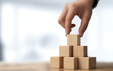 Hand stacking wooden blocks to build a stable structure