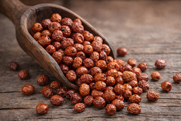 Tiger nuts displayed in a wooden scoop on a rustic table highlighting natural superfood ingredients healthy snacks and organic nutrition