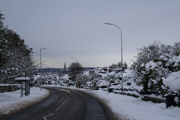 Aberdeen Scotland 6 January 2025 Snow covered main road with in a snowy neighbourhood background