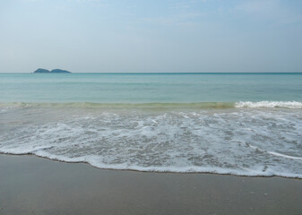 Serene Morning Wave Gently Laps Quiet Sandy Beach Shore.