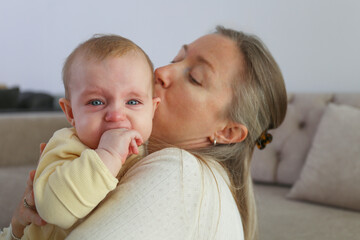 Mother soothing her crying baby. Background.