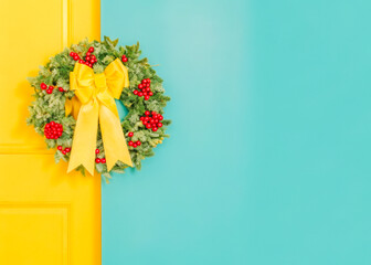 a yellow door with a wreath on it