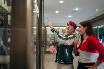 Young women window shopping in city street