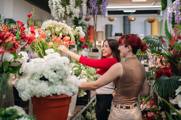 Friends shopping for flowers in plant shop