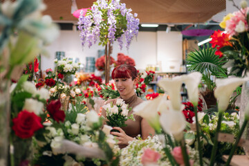 Woman creating floral arrangement in flower shop