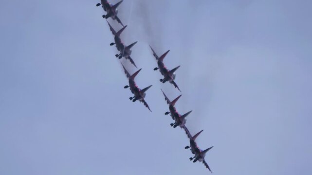 25 July 2021, Russia, Zhukovsky. Russian aerobatic team Swifts performs advanced aerobatic maneuvers in the sky during an air show, demonstrating precision flying and military aviation.