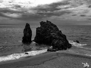 a black and white photograph of the iconic Monterosso al Mare rock formations in Liguria, Italy