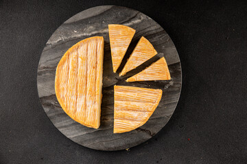 Soft cheese Tartiflette tasty cow milk, goat or sheep French food snack fresh delicious gourmet food background on the table rustic food top view copy space