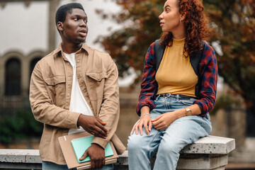 Two college students talking outdoors on campus