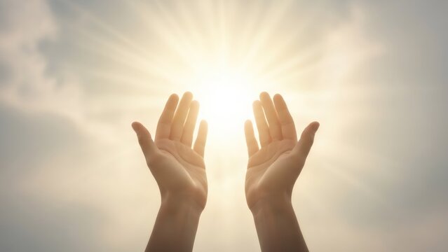 Woman hands reaching up to bright sun rays. Hope concept for spirituality, religion, and freedom. Open palms worshiping, praying, or blessing symbol