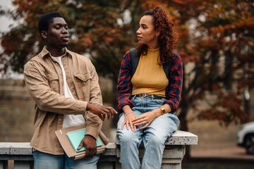 Two college students talking outdoors on campus
