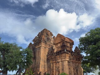 Upward View of Cham Temple: Low angle view looking up at the red brick architecture of an ancient Cham temple.