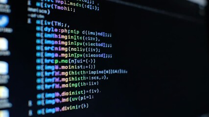 Detailed close up of computer code on a dark screen with blue and yellow text on black background. - Powered by Adobe