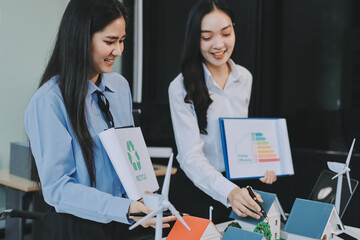 Hands of adult Asian business professionals analyzing ESG financial data and renewable energy project plans