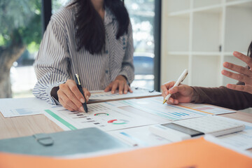 Collaboration and Data: Two individuals analyze documents in a collaborative workspace, their focus sharp as they delve into the core of data