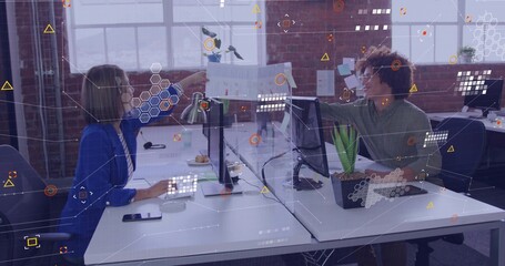 Handing blue-blazer woman and green-shirt man exchanging document at open office, with AR overlays