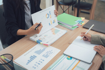 Teamwork in Analysis: A focused moment of collaboration unfolds as professionals meticulously examine detailed financial reports and strategies, deep in thought as they analyze and strategize