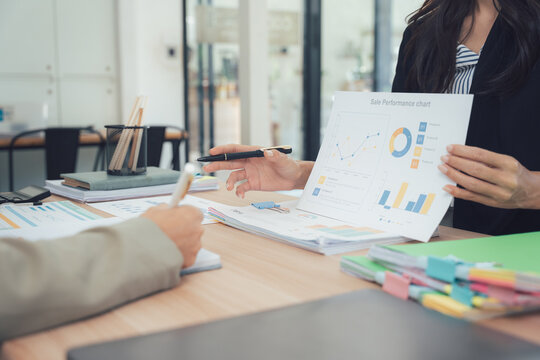 Business Analytics and Analysis: Two business professionals engaged in data analytics, discussing key performance indicators and market insights.