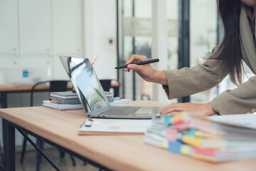 Workplace Insight: A focused individual interacts with a laptop, the scene epitomizing productivity, digital work, and a contemporary workspace environment.
