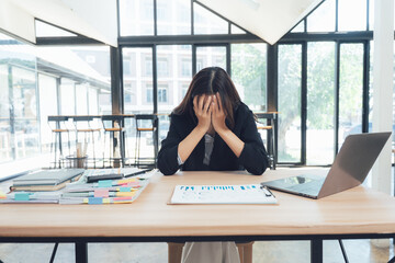 Overwhelmed in the Office: A woman in professional attire struggles with stress and burnout in a demanding workspace, showcasing the pressures of modern professional life.