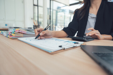 Efficiency in the Workplace: A focused individual meticulously analyzes data, a testament to dedication and precision in the realm of business. It encapsulates the core values of professionalism.