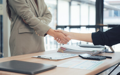 Handshake of Partnership: A close-up shot capturing a pivotal moment of agreement and collaboration with an extended handshake in a professional environment, symbolizing partnership.