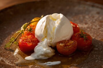 Fresh burrata tears open as warm cream spills over roasted cherry tomatoes