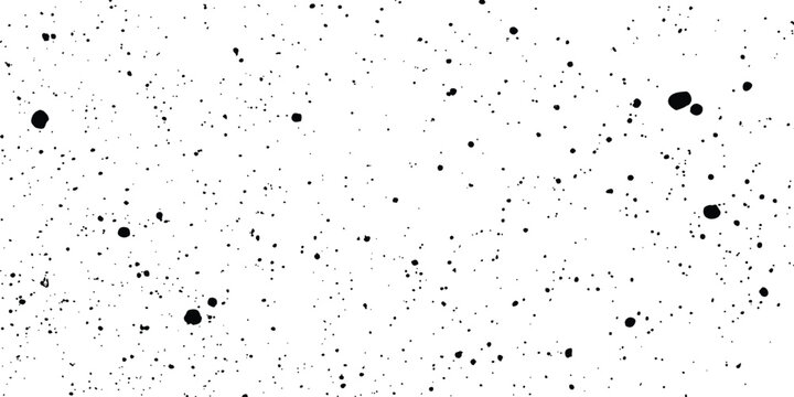 Black speckle and dot texture on a white background creating a seamless grunge pattern. Black and white noise texture with random specks and grain effect for design projects. 