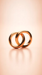 Two interlocking gold wedding bands on reflective surface