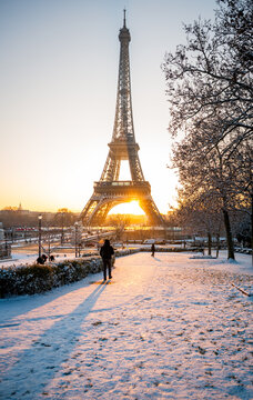 Eiffel Tower in Paris Glowing at Sunrise During Snowy Winter Morning in Paris