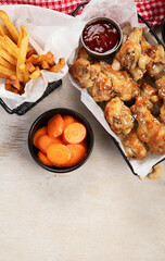 Spicy chicken wings and french fries.