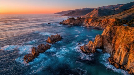 Dramatic coastal cliffs at sunset with vibrant ocean waves and rugged mountains.