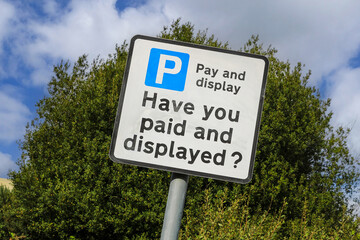 A sign saying " pay and display" and "have you paid and displayed", England, UK